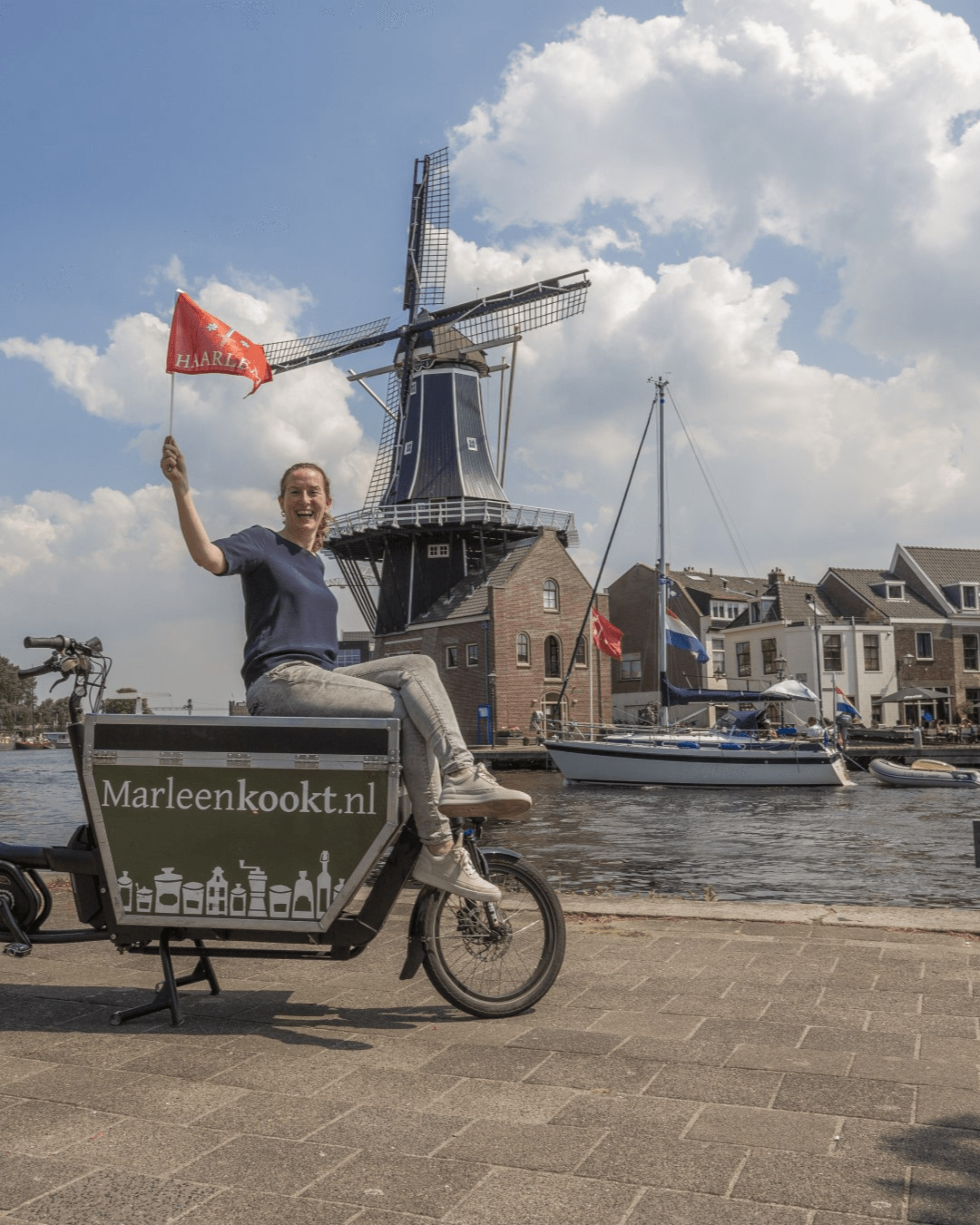 Marleen op de bakfiets bij de molen in Haarlem
